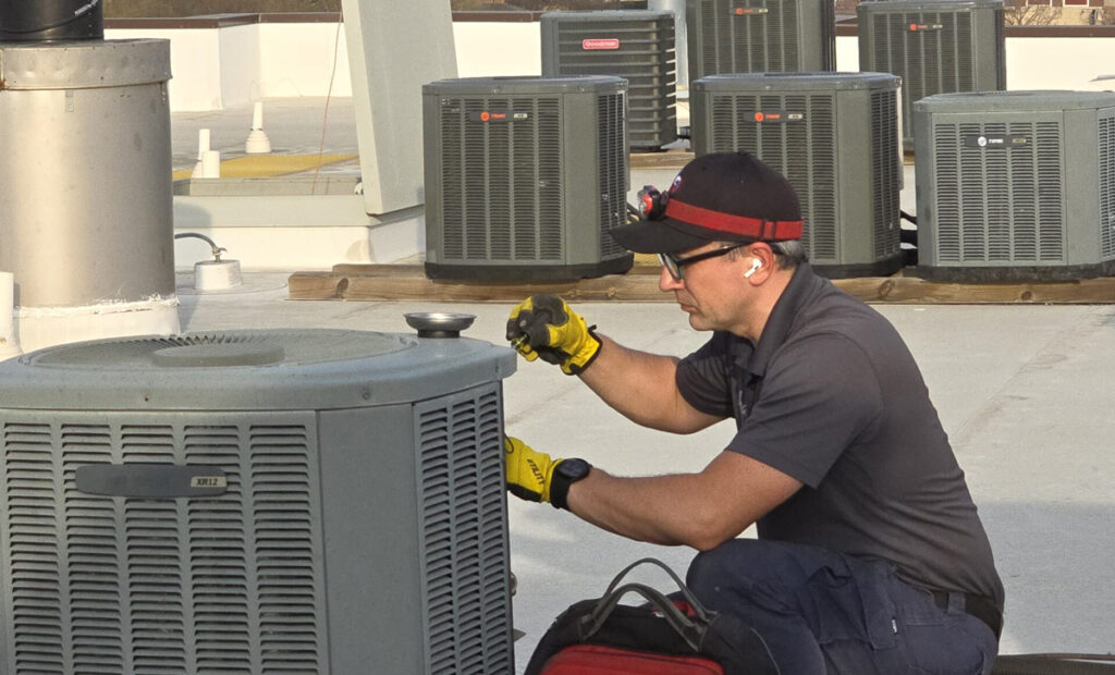 A technician is performing-regular-ac-maintenance