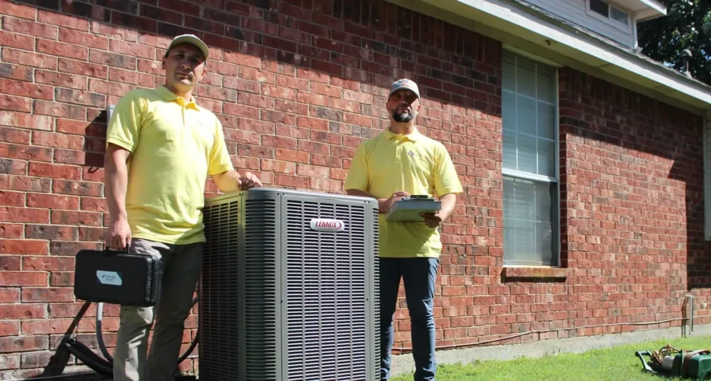 An HVAC technician is installing a new outdoor air conditioning unit at a residential property, ensuring the unit is connected to the existing ductwork for optimal indoor air quality and energy efficiency. This professional installation aims to enhance cooling capacity while potentially lowering energy costs during hot Texas summers.