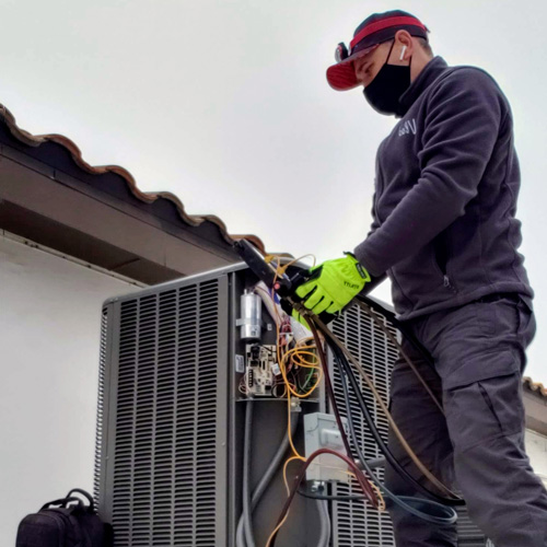 technician performs ac repairs